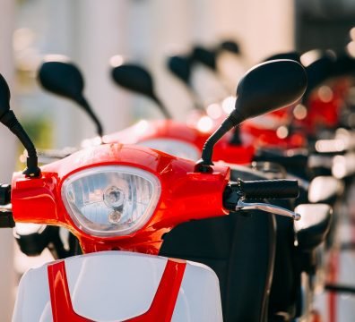 Many Electric Motorbikes, Motorcycles Scooters Parked In Row In